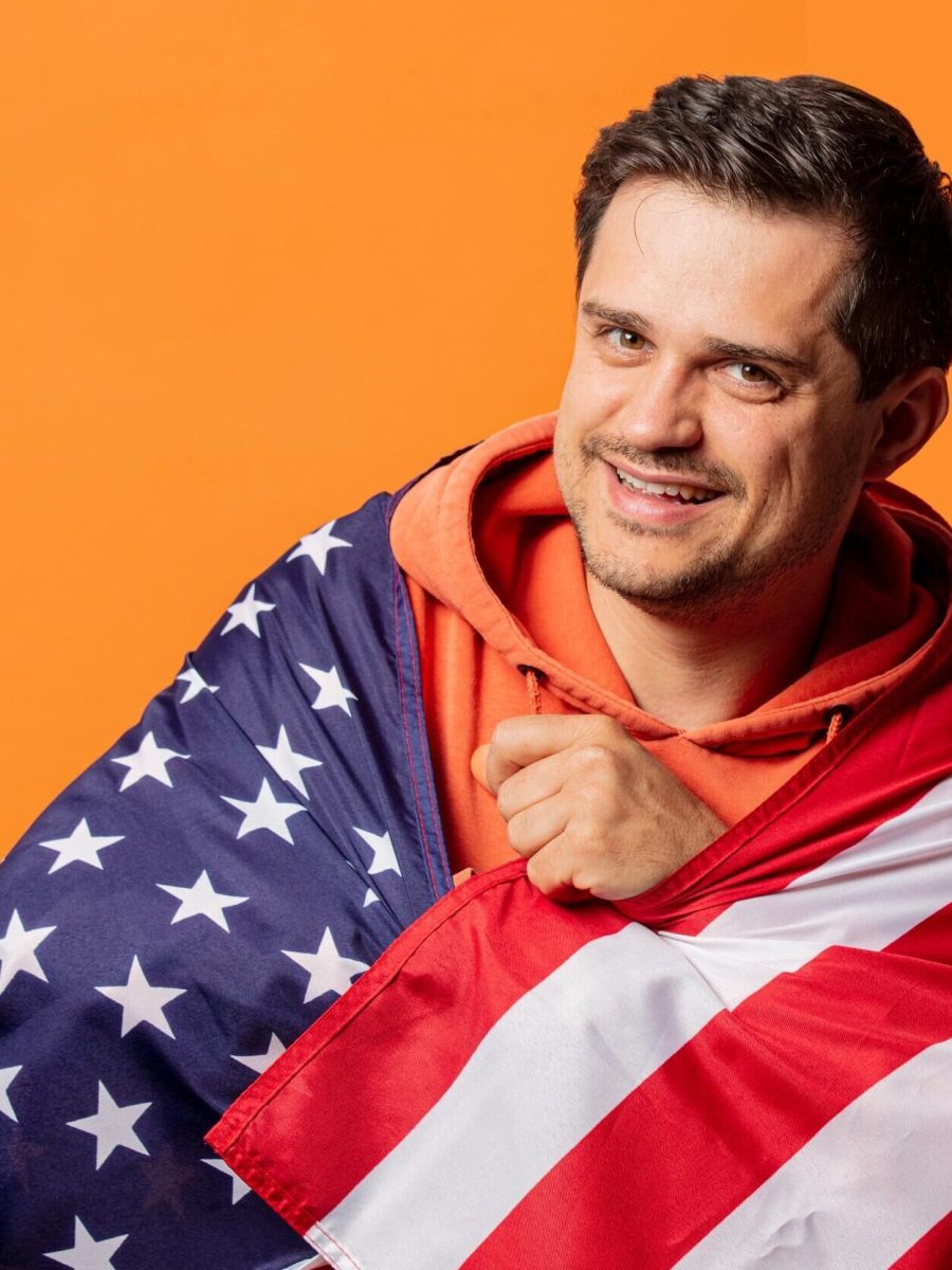 smiling-guy-in-orange-hoodie-with-usa-flag-2024-09-25-07-32-24-utc (1)